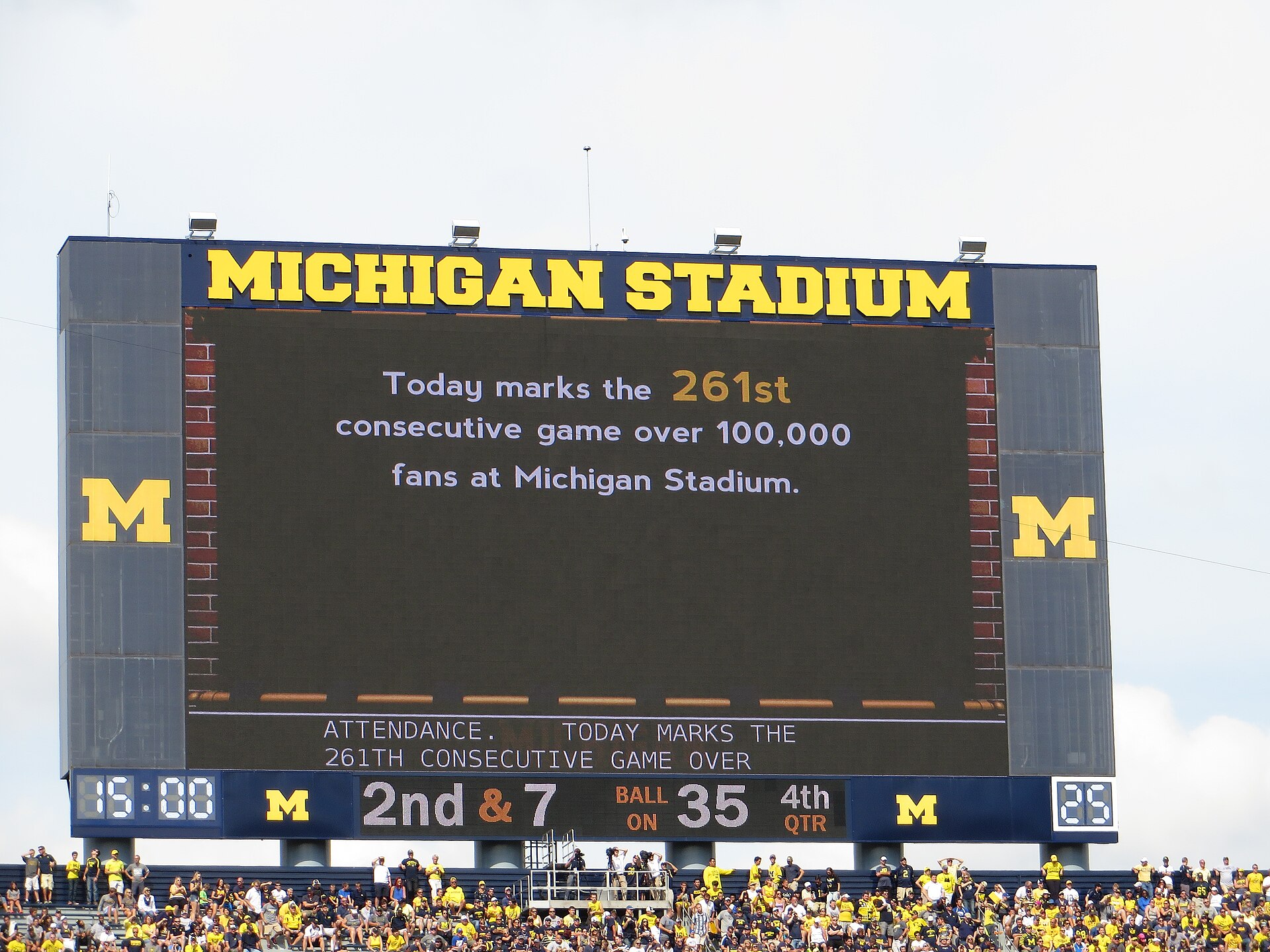 A packed Michigan Stadium during a night game, the Big House lit up with more than 100,000 fans in the stands