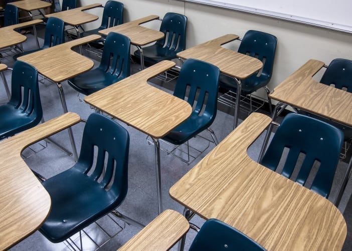 Empty high school classroom with rows of desks