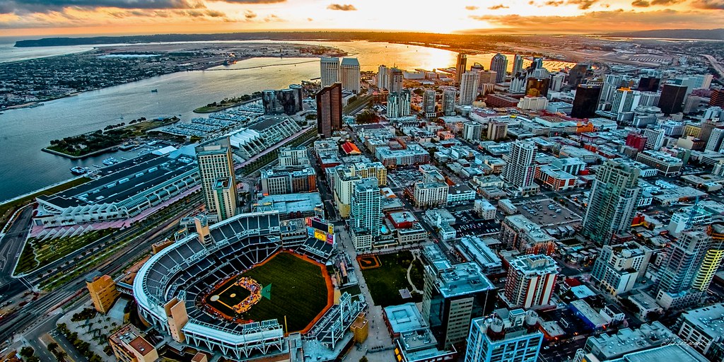 Petco Park in San Diego at golden hour, the downtown skyline behind the stadium bowl