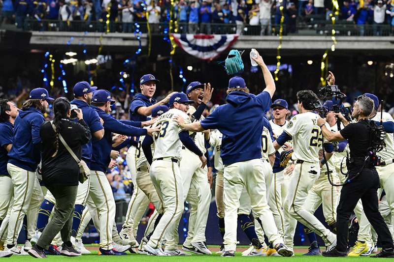 The Milwaukee Brewers celebrate a postseason win at American Family Field as confetti falls