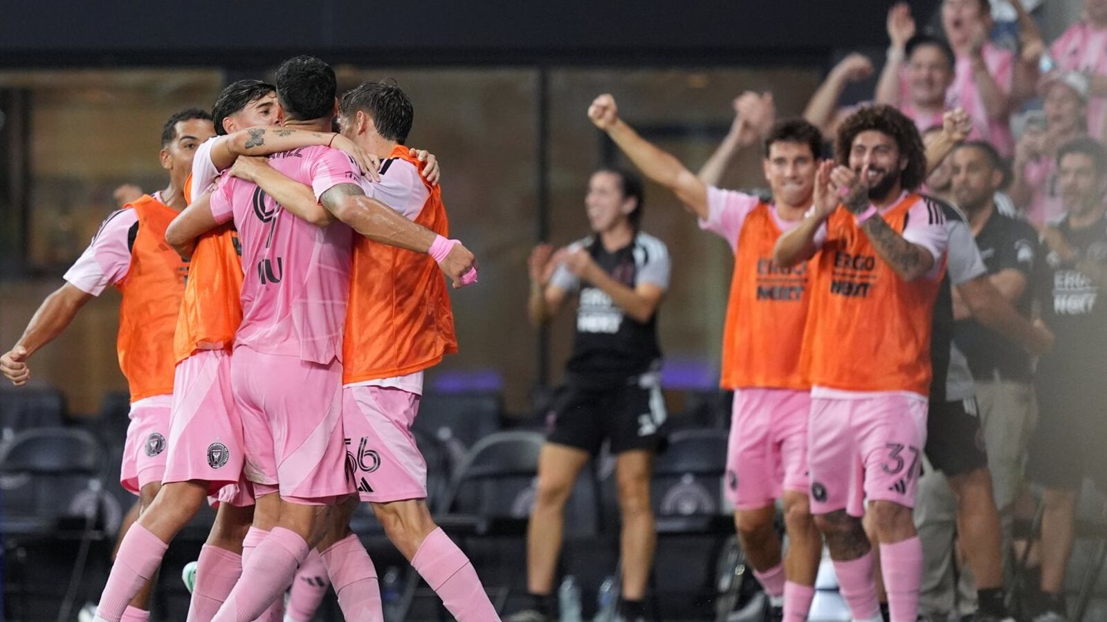 Inter Miami CF players in pink shirts mob a teammate in celebration in front of the bench and the home crowd at Nu Stadium — the 90th-minute equalizer celebration against FC Cincinnati, October 28, 2026 (wire photo published by TSN)