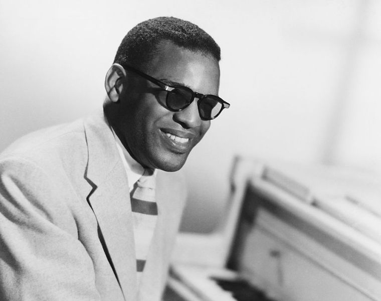 Ray Charles at the piano in a classic portrait.