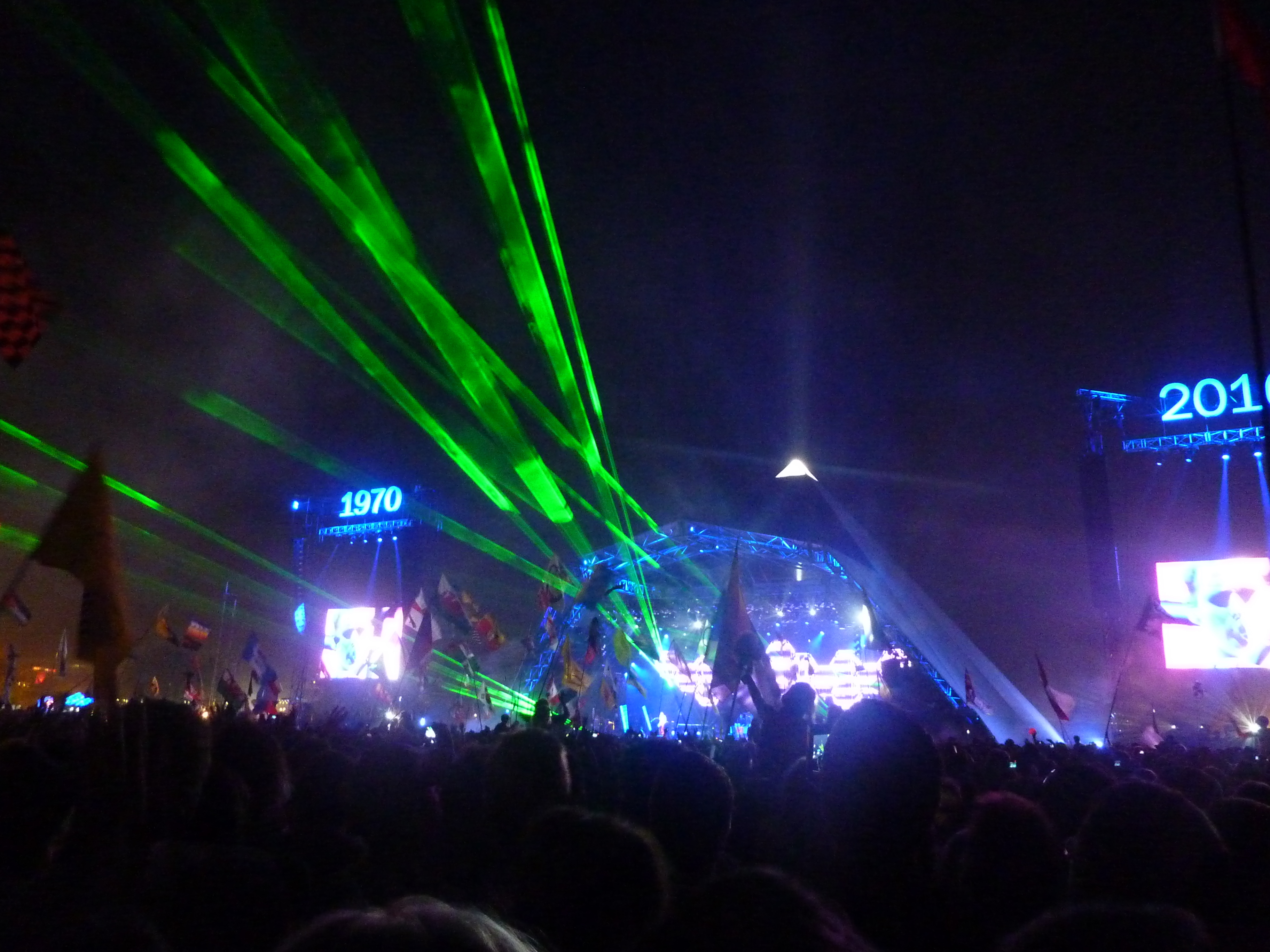 The Pyramid Stage at Glastonbury Festival with a huge crowd gathered in front of it