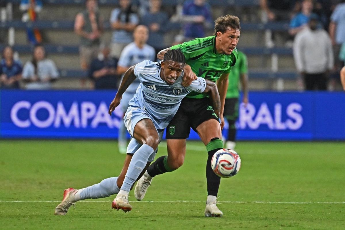 Sporting Kansas City's Andre Luiz and Austin FC's Guilherme Biro battle for the ball at Sporting Park