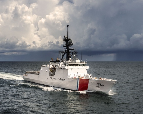 A U.S. Coast Guard cutter underway on the open ocean in daylight
