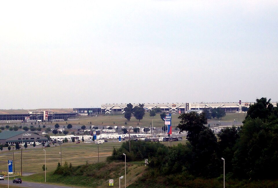 Race cars at speed around Charlotte Motor Speedway's 1.5-mile oval