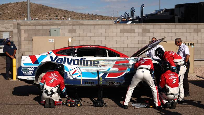 Crew members repair Kyle Larson's No. 5 Chevrolet in the garage at Phoenix Raceway