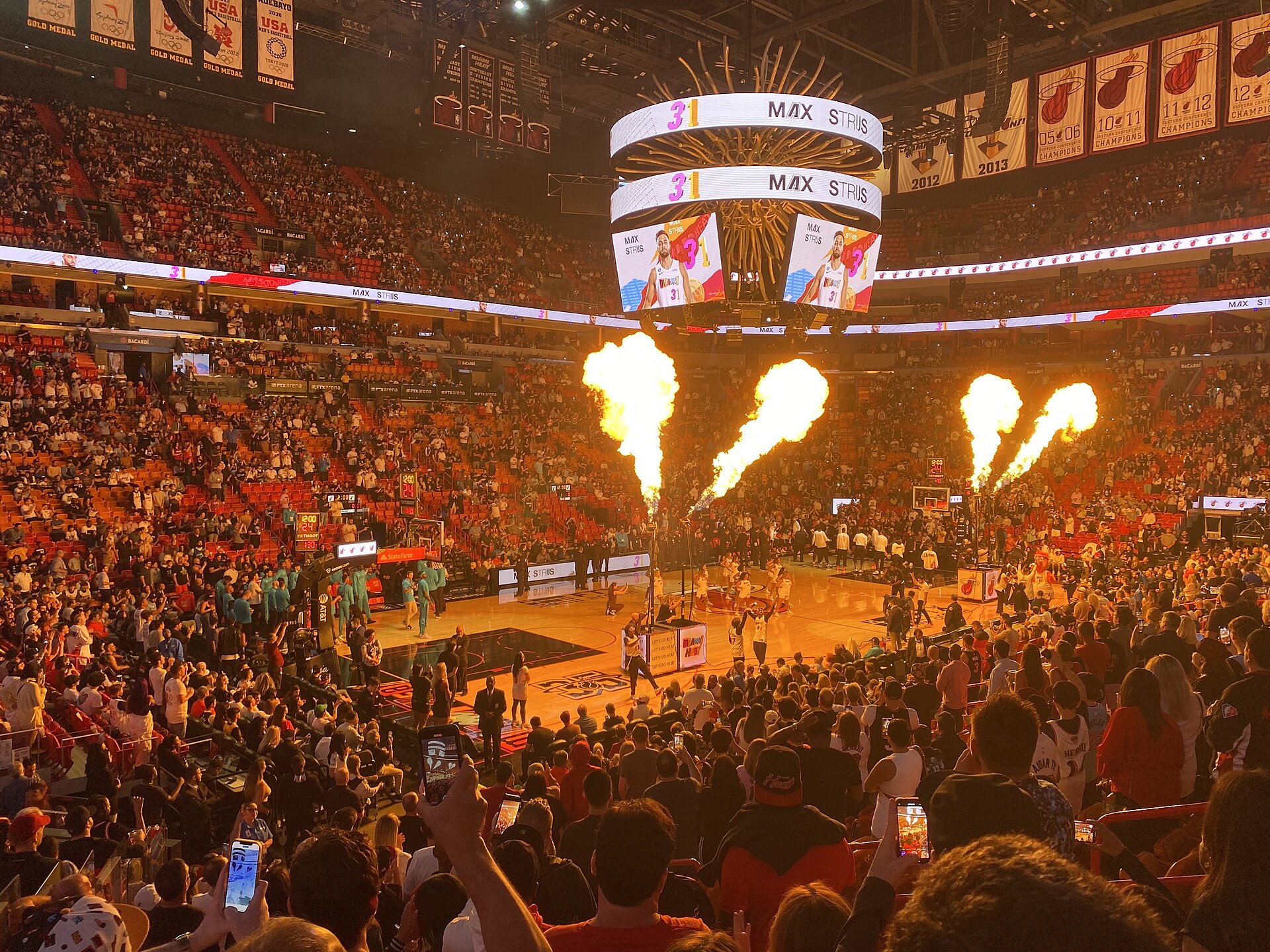 Player introductions before a Miami Heat game, with fireworks over a packed arena
