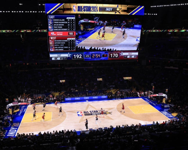 NBA game action under the bright lights of a sold-out arena during a televised game