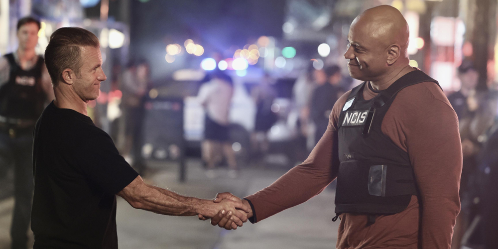 LL Cool J and Scott Caan shaking hands while filming NCIS: New York on location in New York