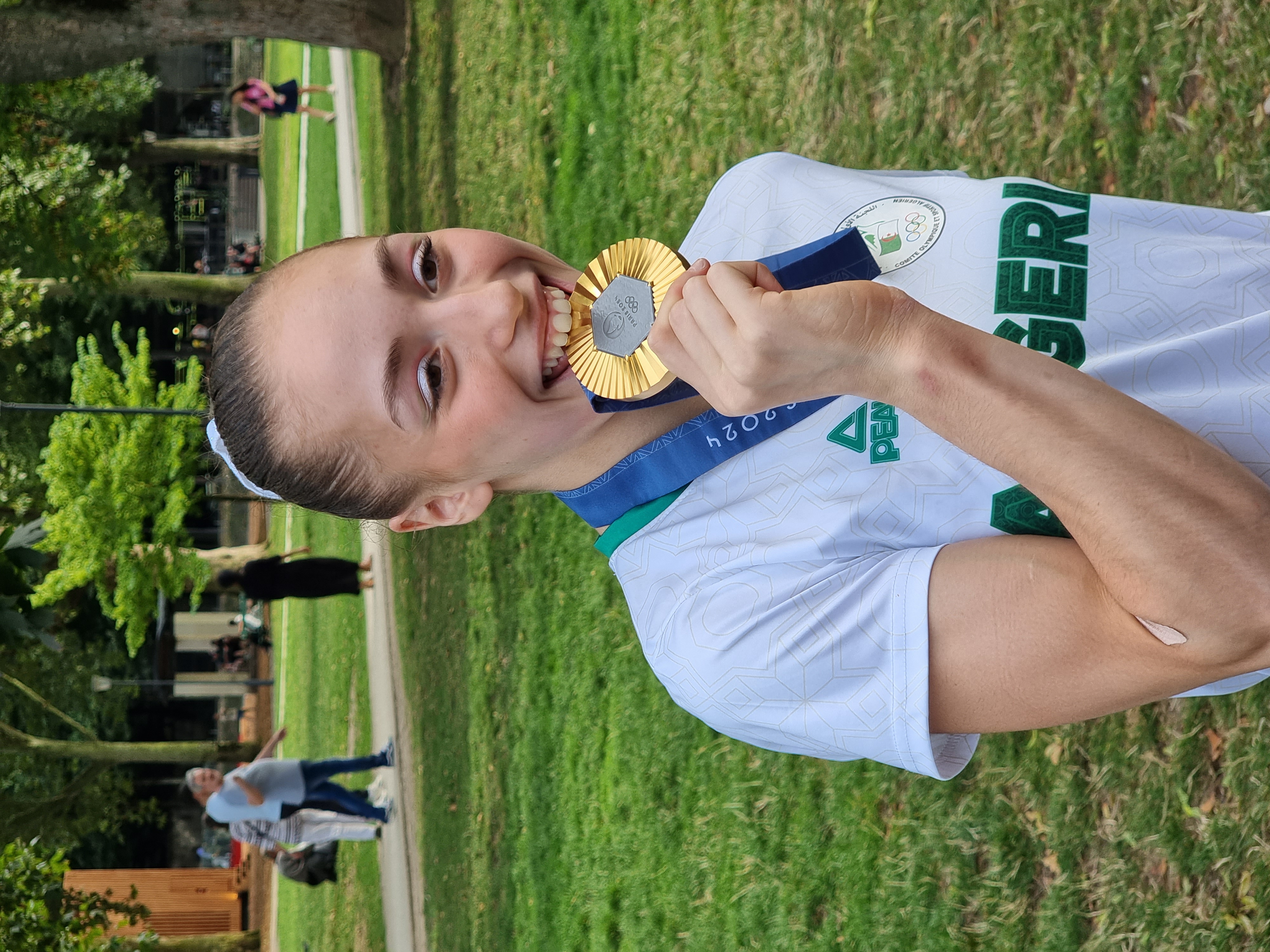 Kaylia Nemour of Algeria with her gold medal on the uneven bars at the Paris 2024 Olympics