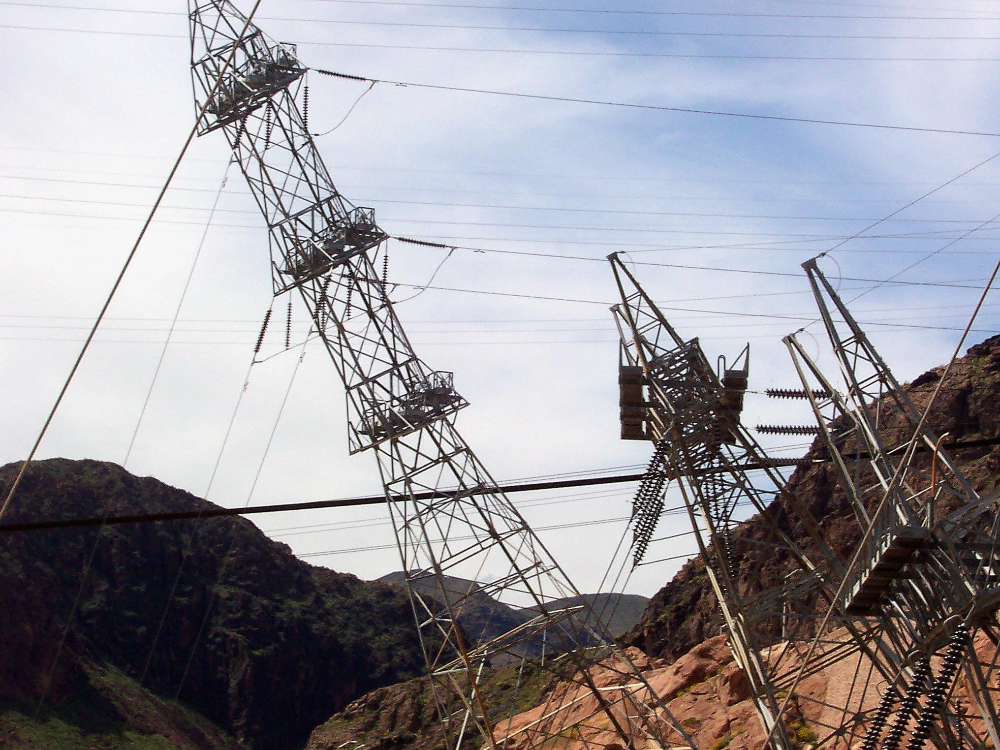 High-voltage transmission towers carrying power lines across the Nevada desert