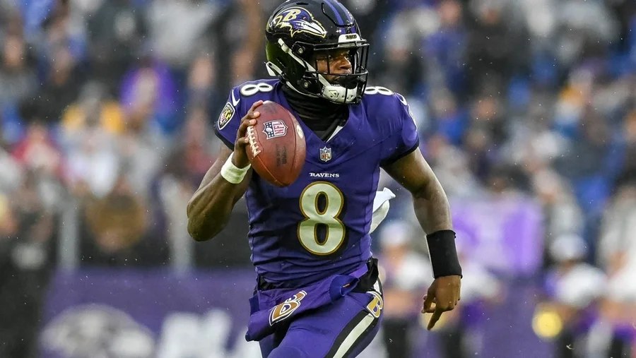 Baltimore Ravens quarterback Lamar Jackson scrambling with the football during a game