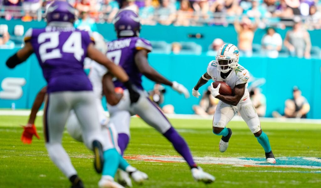 Minnesota Vikings and Miami Dolphins players on the field during a game.