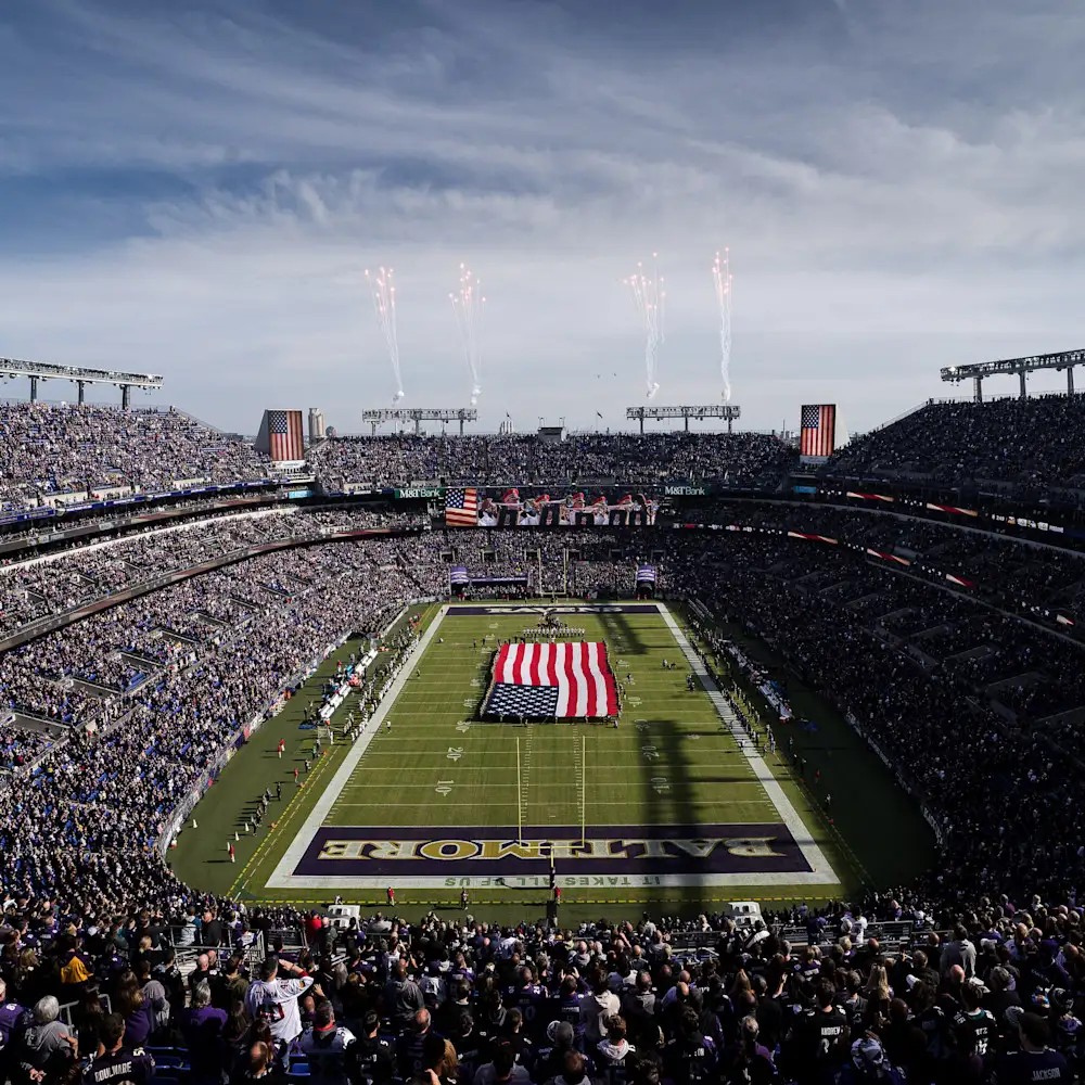 M&T Bank Stadium in Baltimore during pregame ceremonies, with a giant American flag on the field.