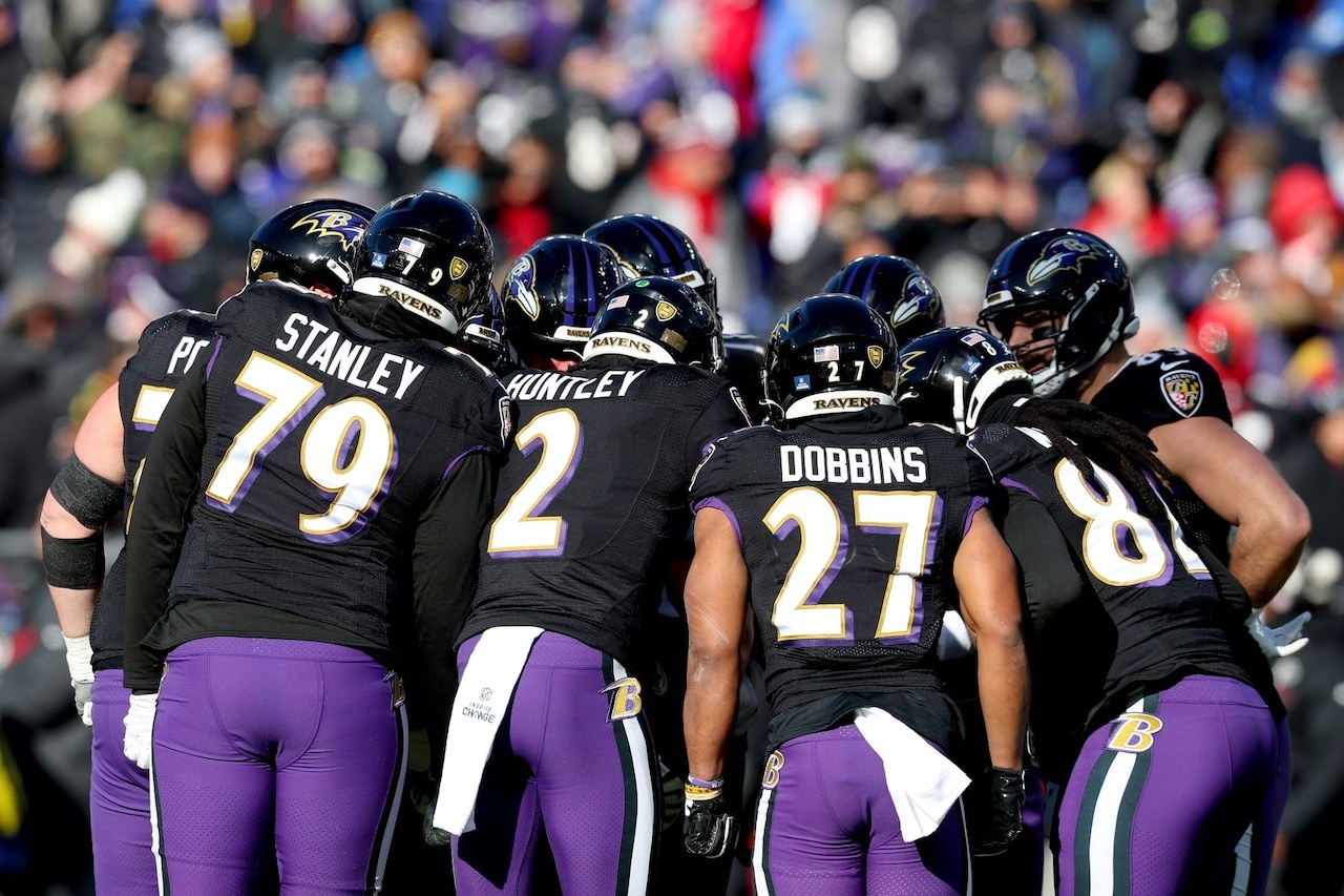 The Baltimore Ravens huddle up during an NFL game