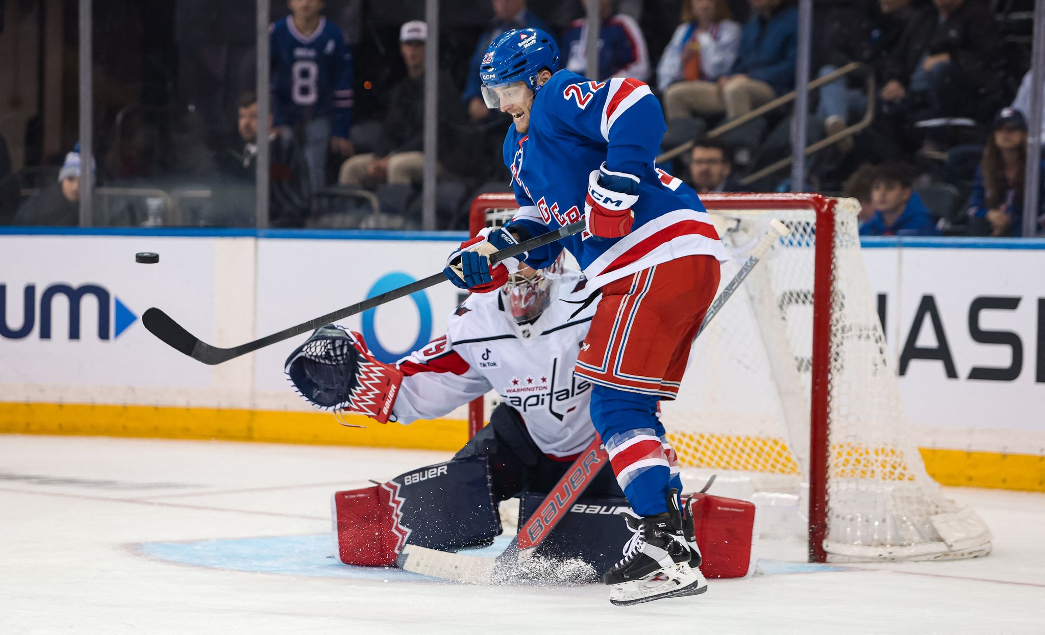 A New York Rangers forward fires on the Washington Capitals' net — the Capitals took Friday's rivalry game 3-1 after Igor Shesterkin left with a lower-body injury.