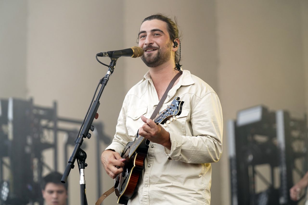 Noah Kahan performing on stage during his Fenway Park concert.