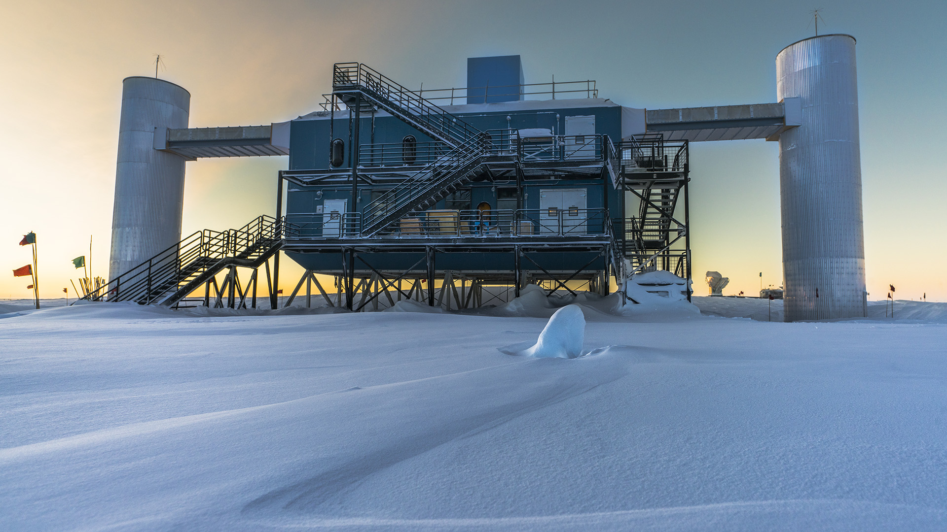 The IceCube Laboratory at the South Pole at sunset, the surface facility above a cubic kilometer of Antarctic ice wired with neutrino detectors
