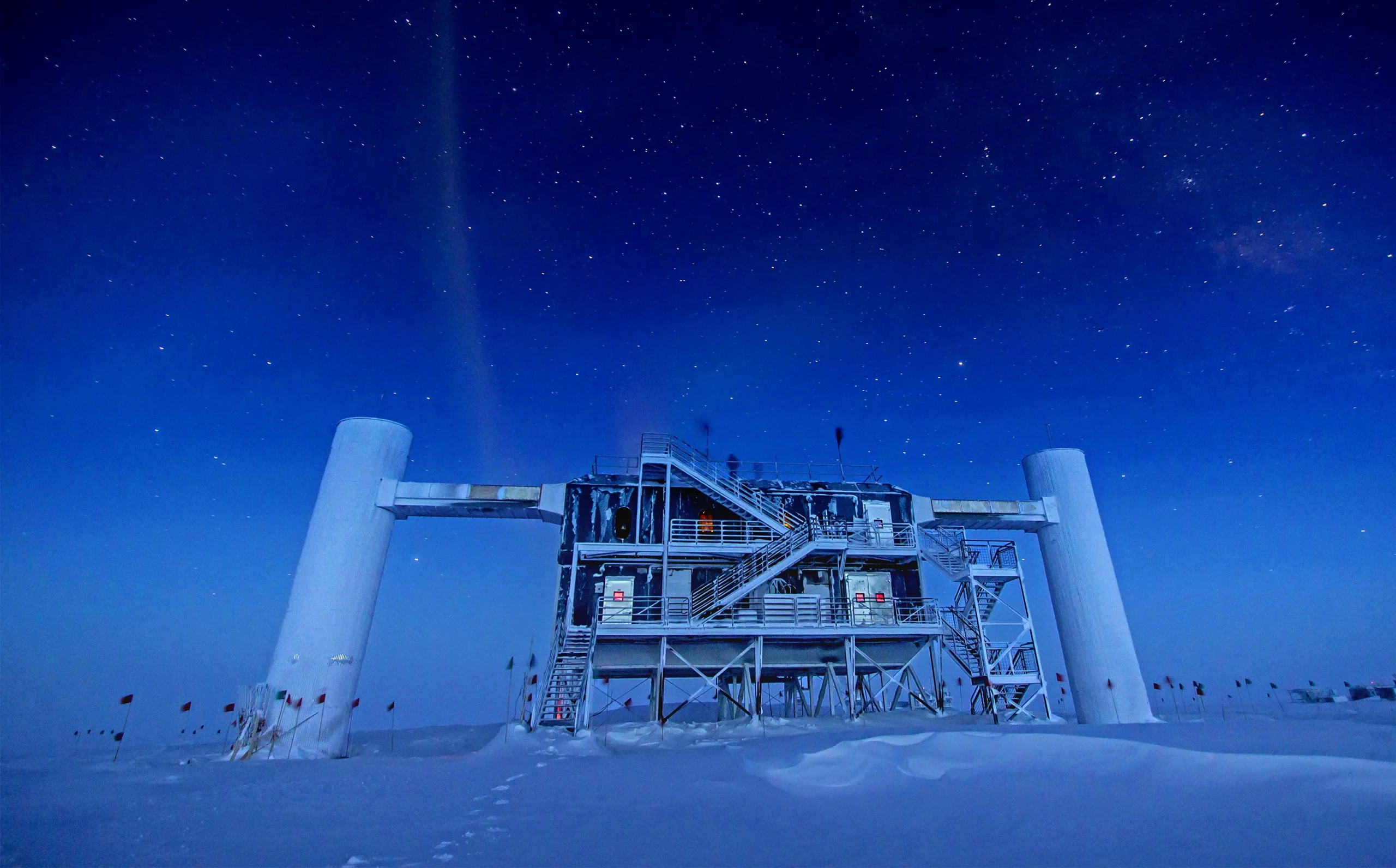 The IceCube Laboratory building at the South Pole under a starry night sky