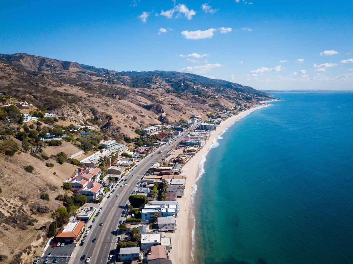 Pacific Coast Highway curving through Malibu on a bright day