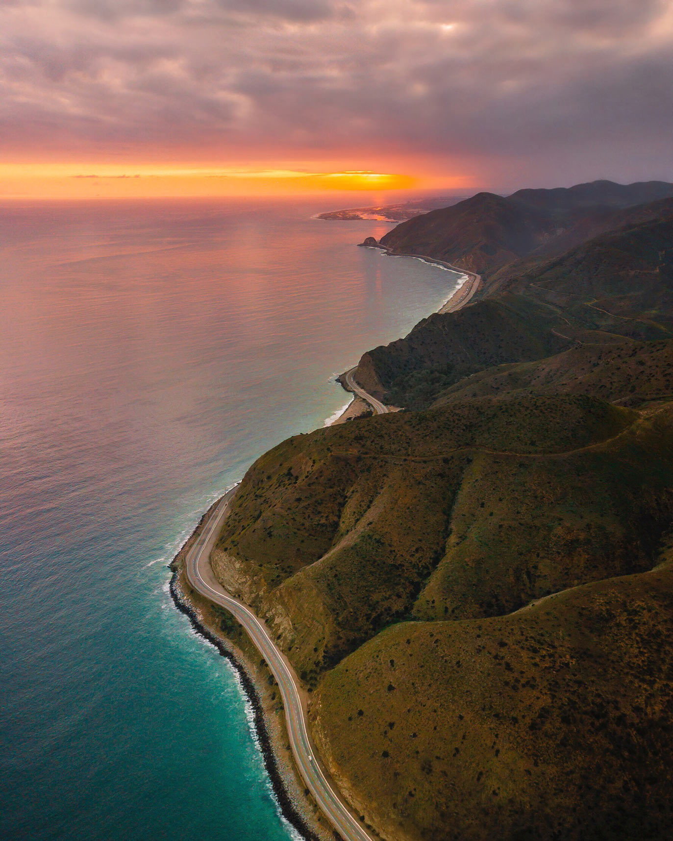 The Pacific Coast Highway shoreline with traffic along the road