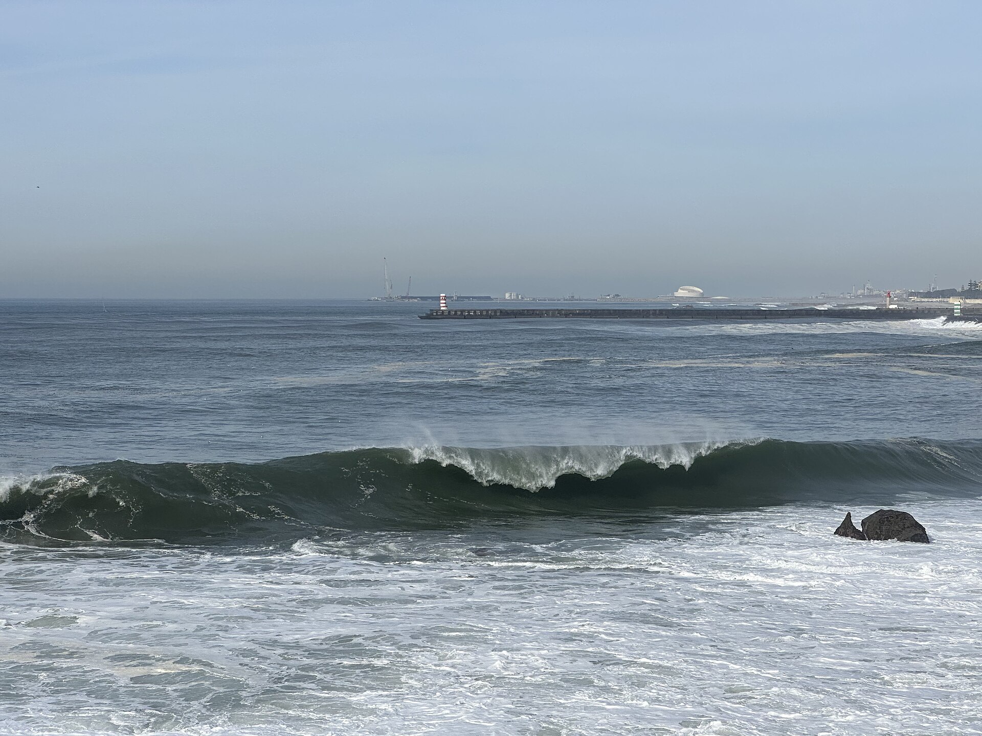 A large ocean wave crashing near shore in daylight (file photo)