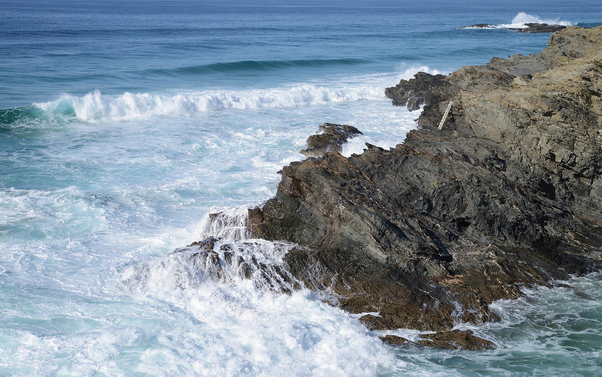 Waves rolling toward a rocky shoreline (file photo)