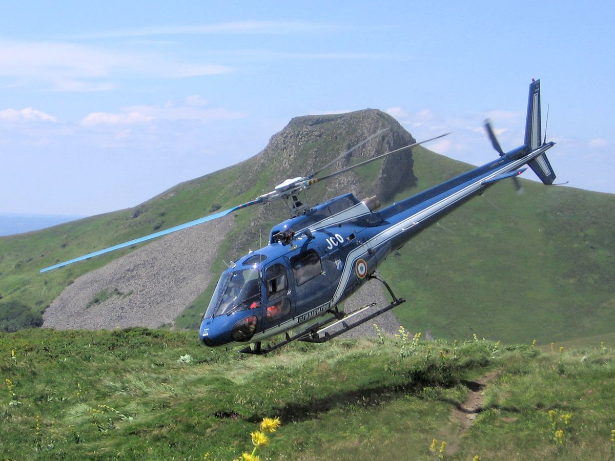 A helicopter in flight in daylight.