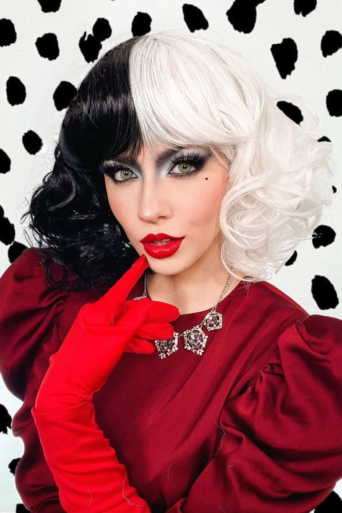 Cruella-style Halloween costume makeup with dramatic red and black styling