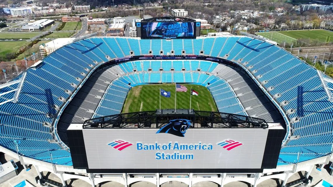 Bank of America Stadium in Charlotte lit up at night.