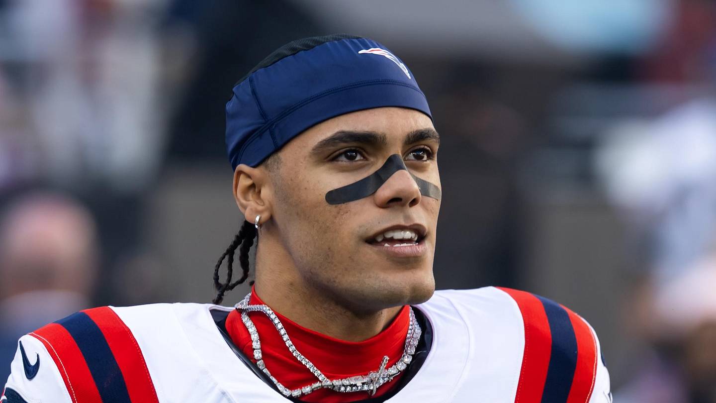 New England Patriots cornerback Christian Gonzalez on the field in a white road jersey