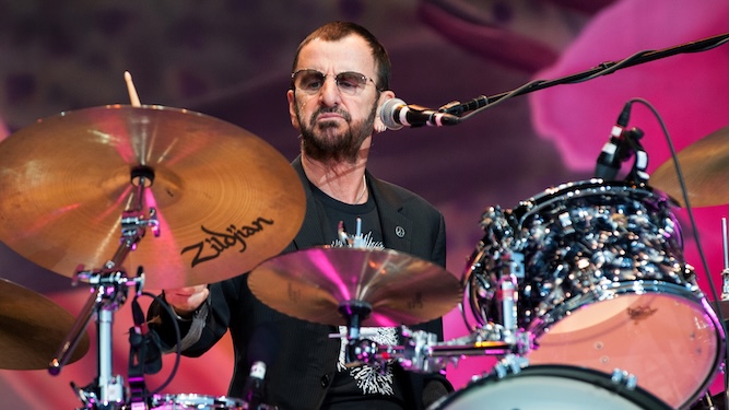 Ringo Starr playing drums on stage during a live concert