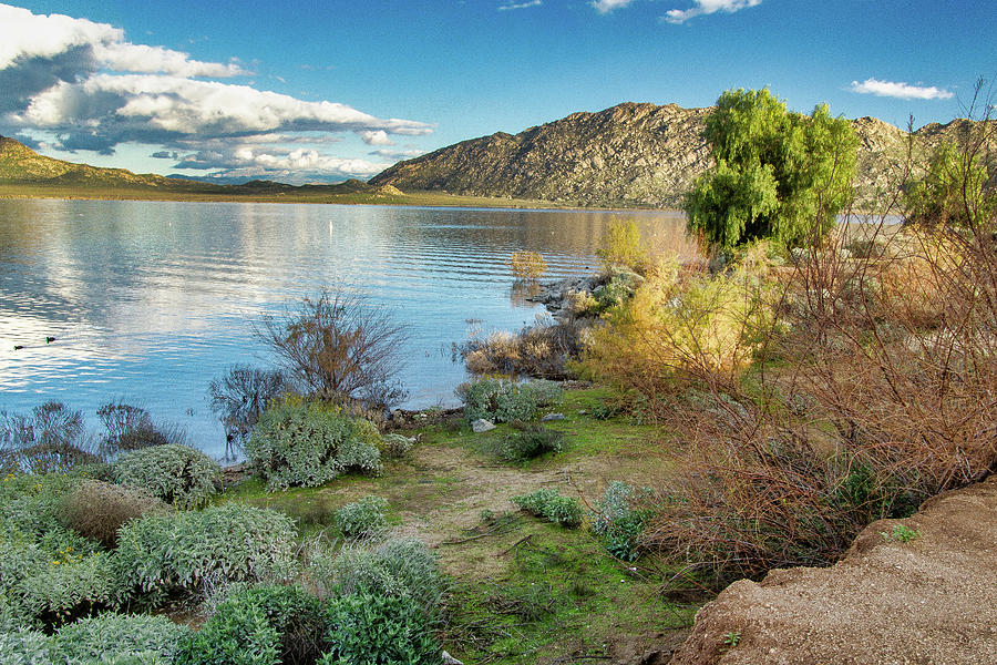 Lake Perris with hills and water under a clear sky