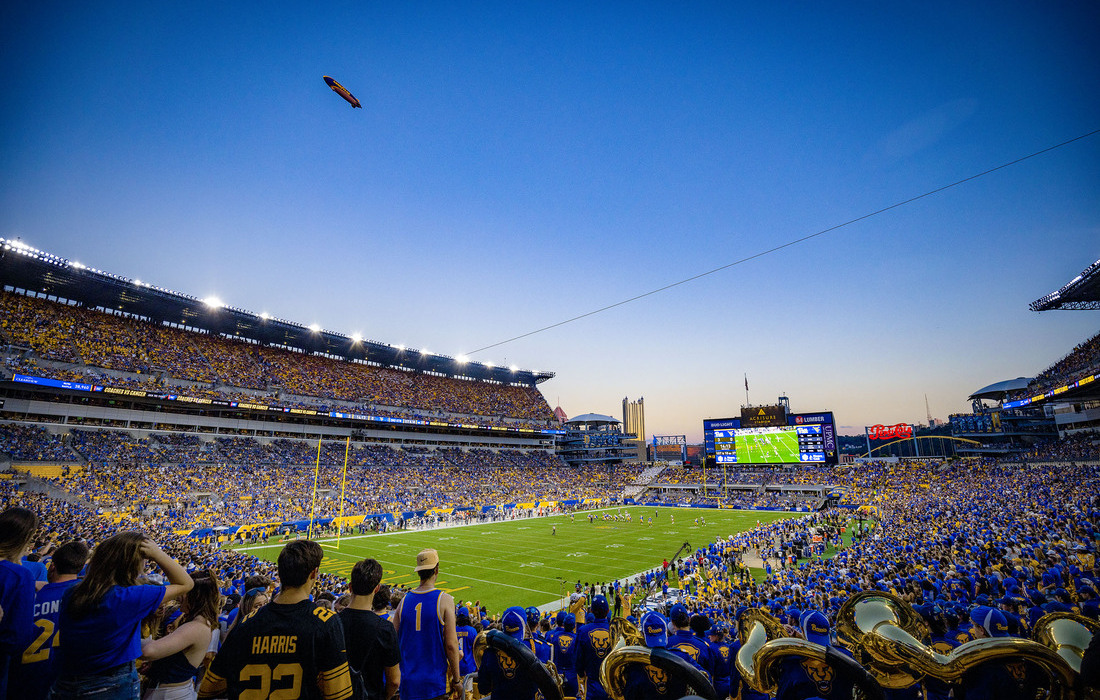 Acrisure Stadium packed with Pitt fans in blue and gold, PITTSBURGH spelled in the end zone