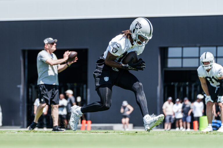 A Raiders wide receiver running a route at practice