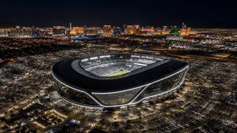 Allegiant Stadium at night with the Las Vegas skyline