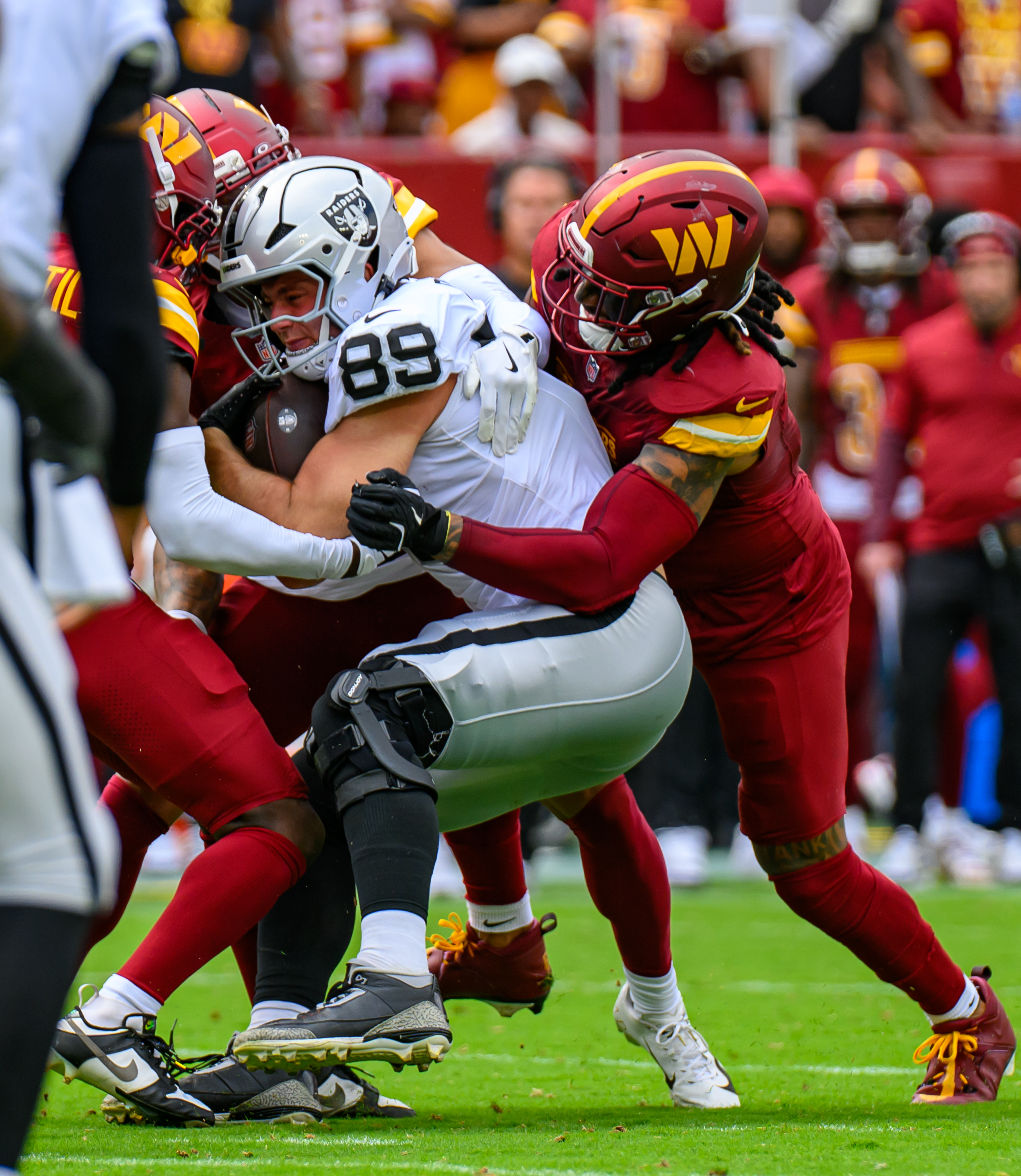 Las Vegas Raiders tight end Brock Bowers (89) is tackled during an NFL game