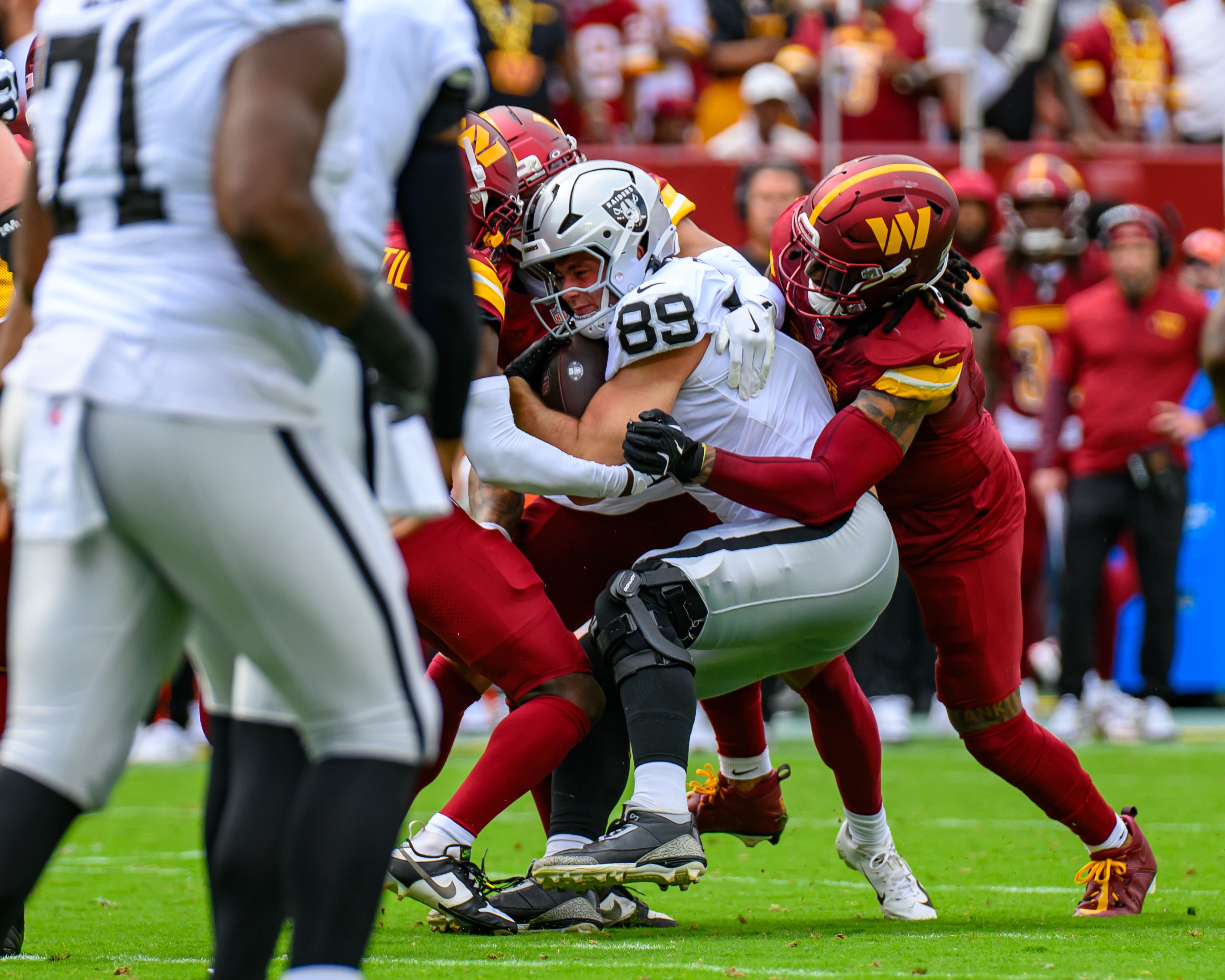 Brock Bowers (89) of the Raiders fights through a tackle during a 2025 game