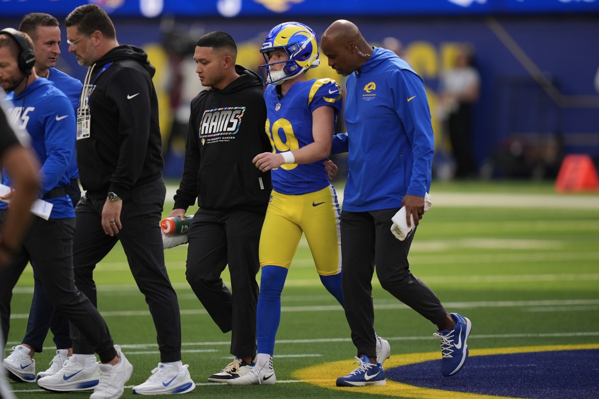 Los Angeles Rams kicker Blake Grupe walks off the field with trainers after injuring his knee against the Arizona Cardinals