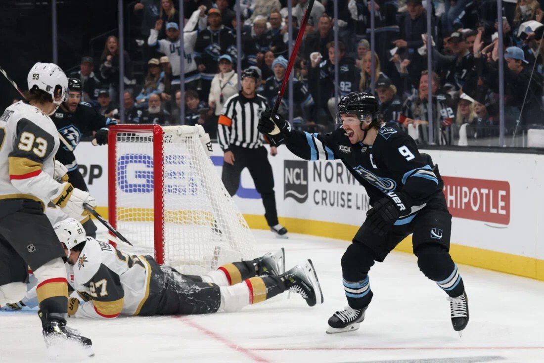 Utah Mammoth forward Clayton Keller celebrating a goal in the black and blue uniform.