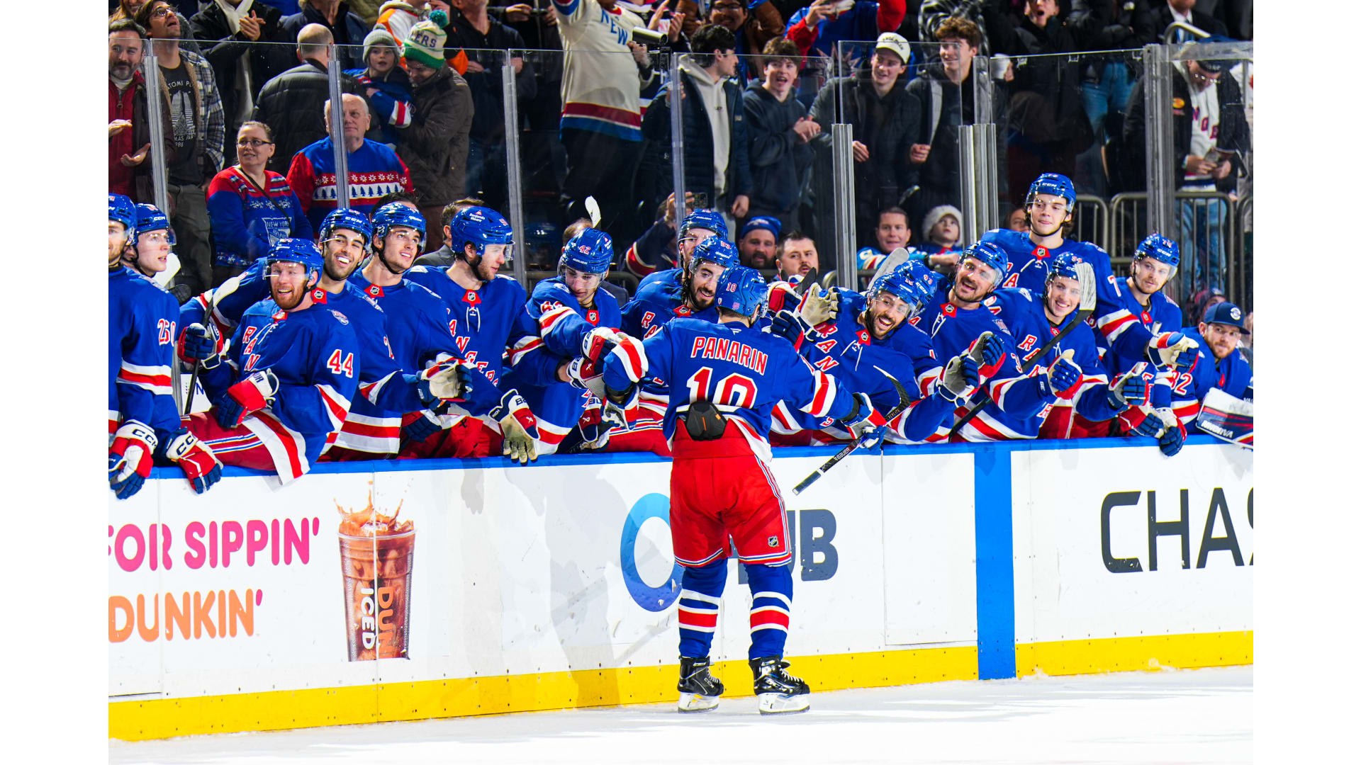 New York Rangers skaters celebrating at Madison Square Garden.