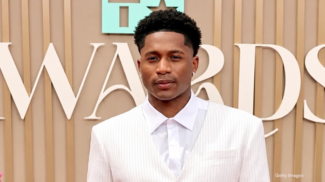 Da'Vinchi in a white pinstripe suit and white shirt on the BET Awards red carpet