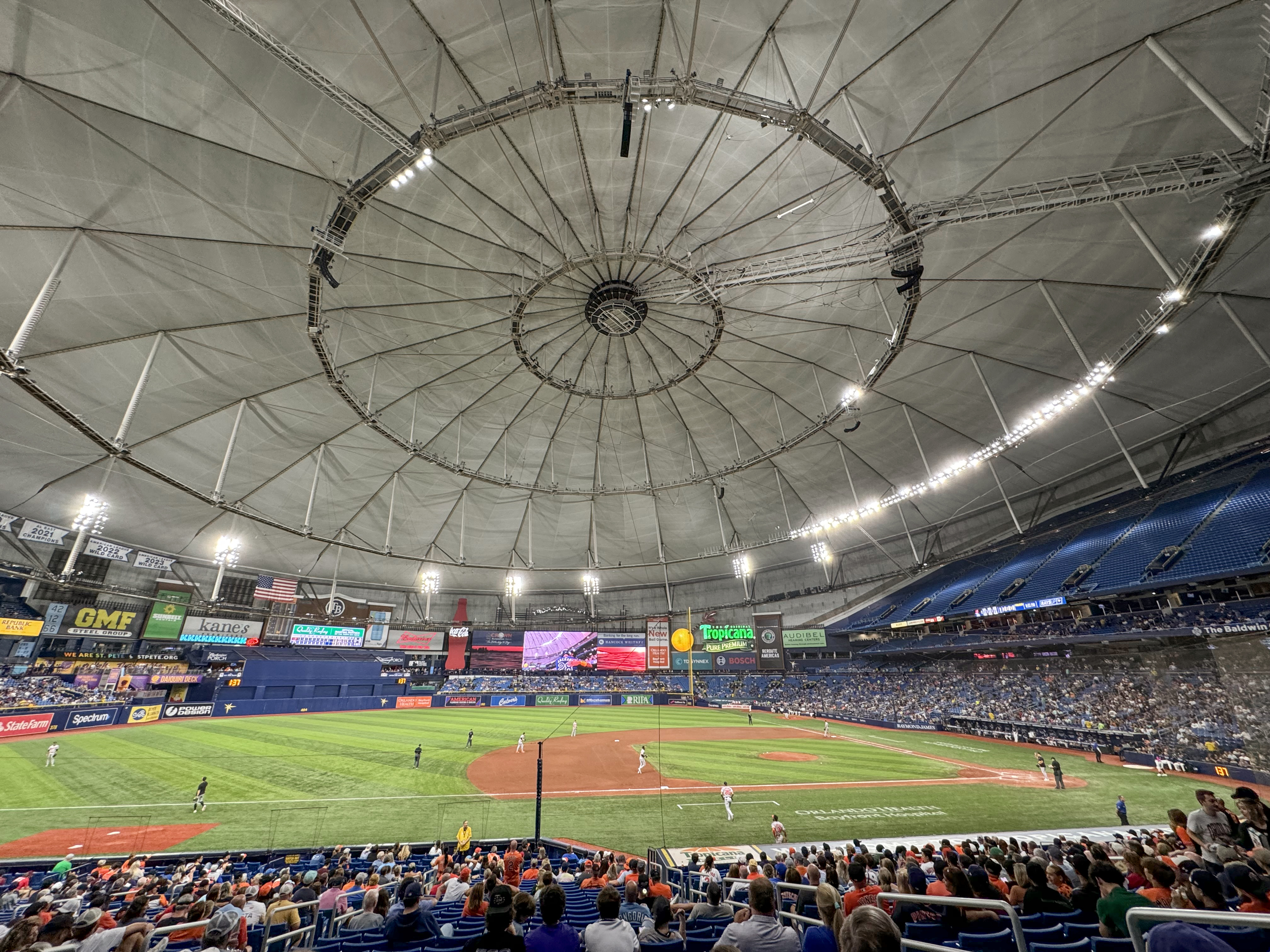 The interior of Tropicana Field in St. Petersburg during a Tampa Bay Rays game, the centre-field scoreboard visible beyond the outfield — 2024 file photo