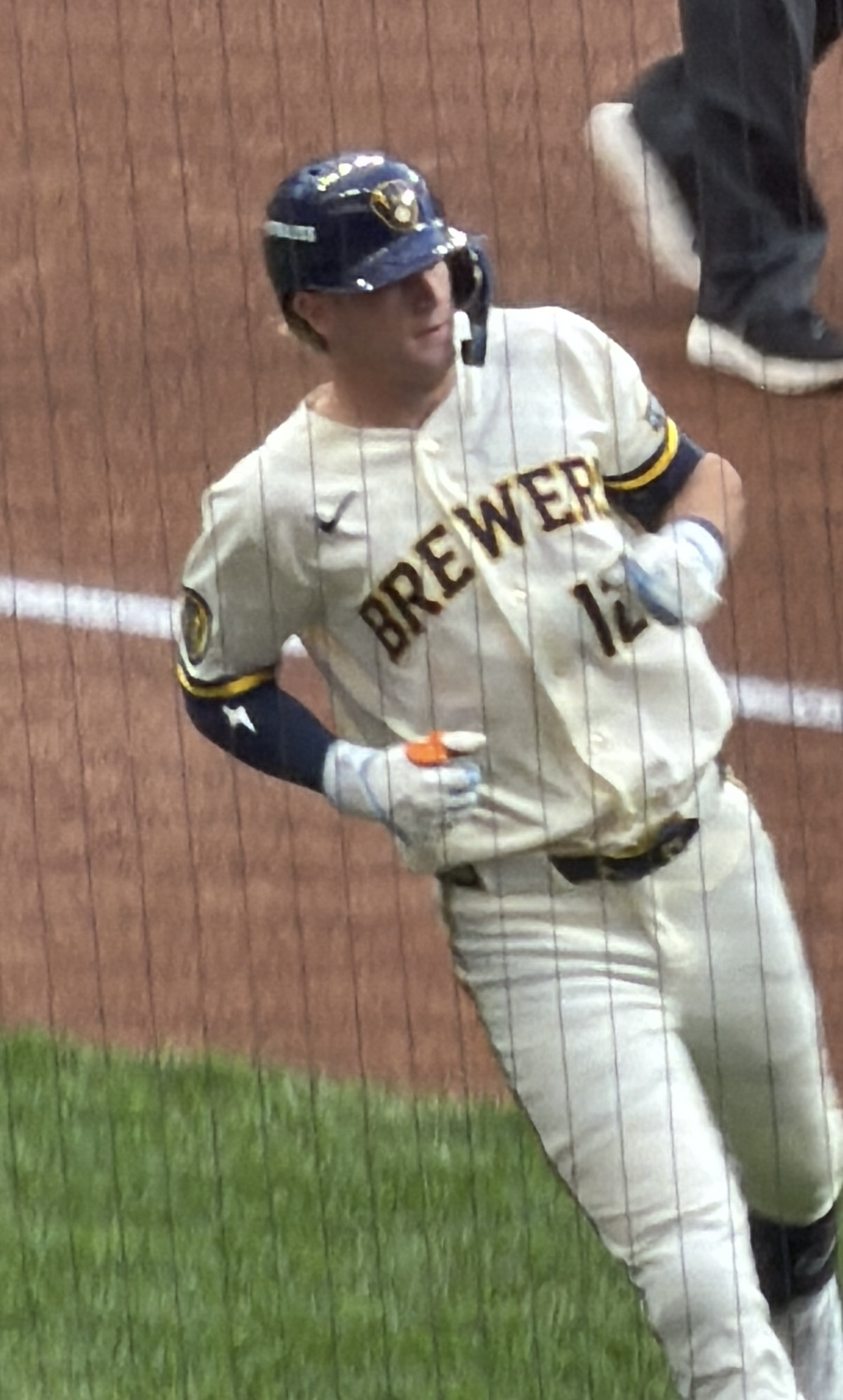 Cooper Pratt of the Milwaukee Brewers, in the club’s cream home uniform and navy helmet, running towards first base during Game 2 of the 2026 NLCS at American Family Field — file photo