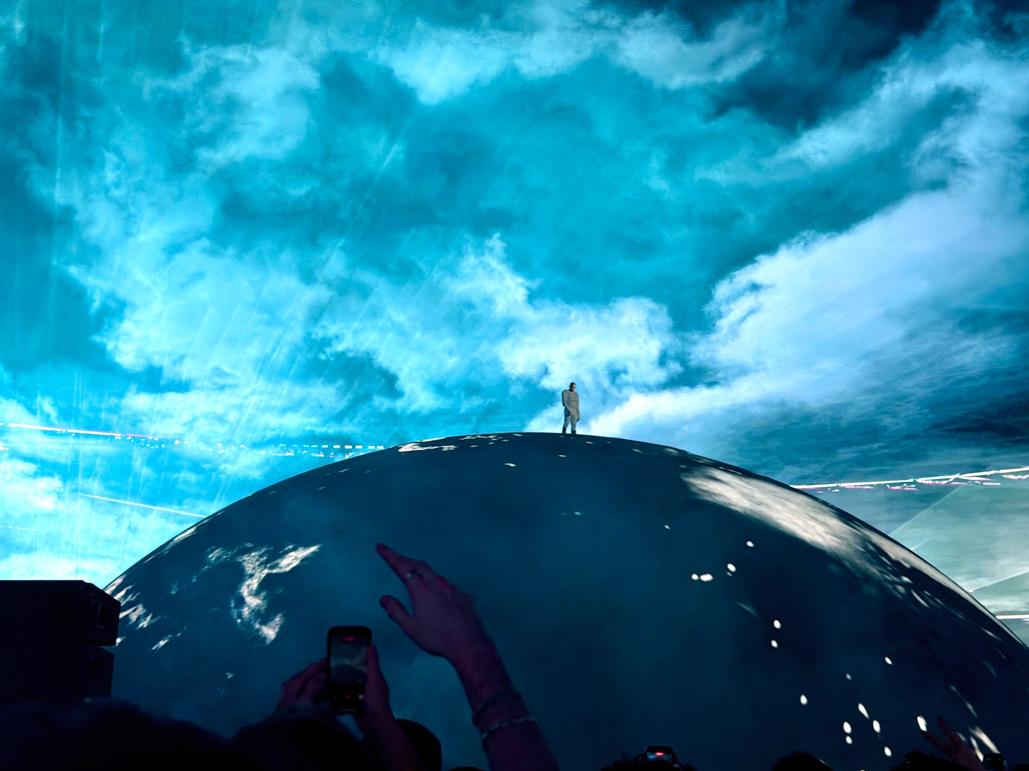 Ye standing atop the 360-degree globe stage at Gelora Bung Karno Main Stadium in Jakarta, the dome lit with its Earth projection, during his first solo concert in Indonesia on October 24, 2026