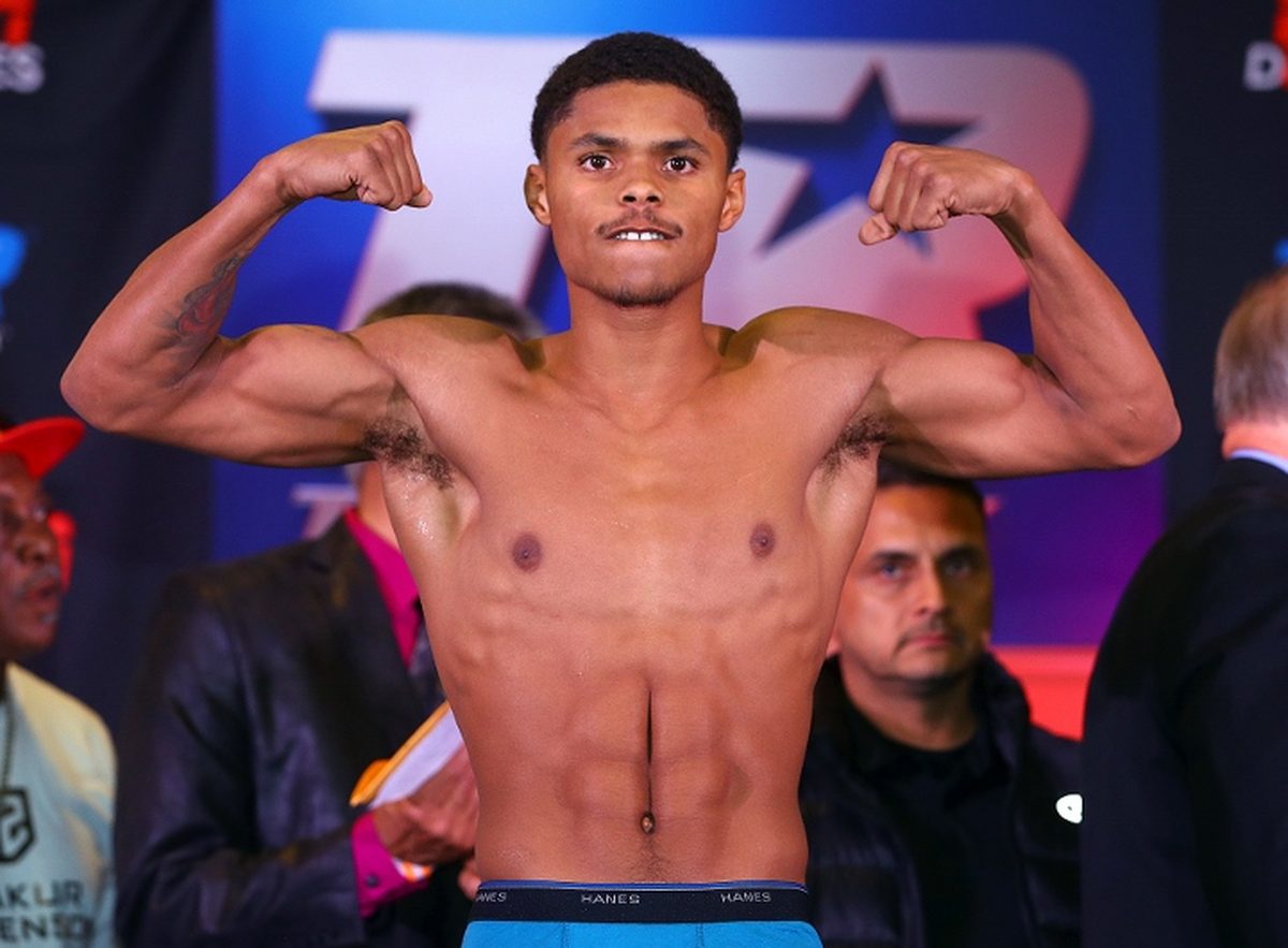 Shakur Stevenson flexes at a weigh-in — the unbeaten four-division champion has agreed to meet Devin Haney at 145 pounds