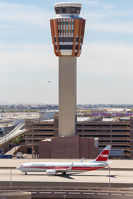 An airliner taxiing beneath the Sky Harbor control tower