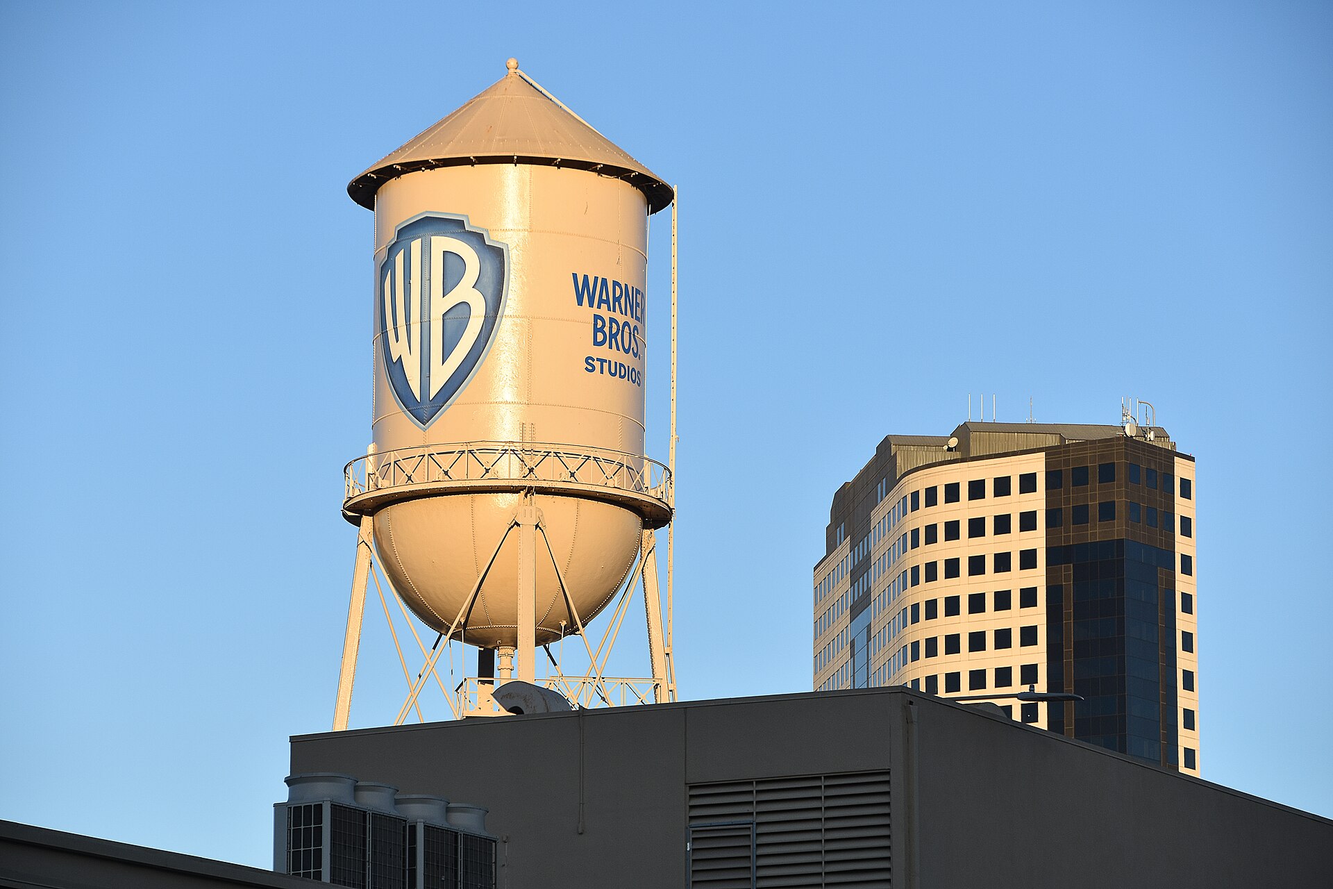 The iconic Warner Bros. Studios water tower against a clear blue sky in Burbank, California.