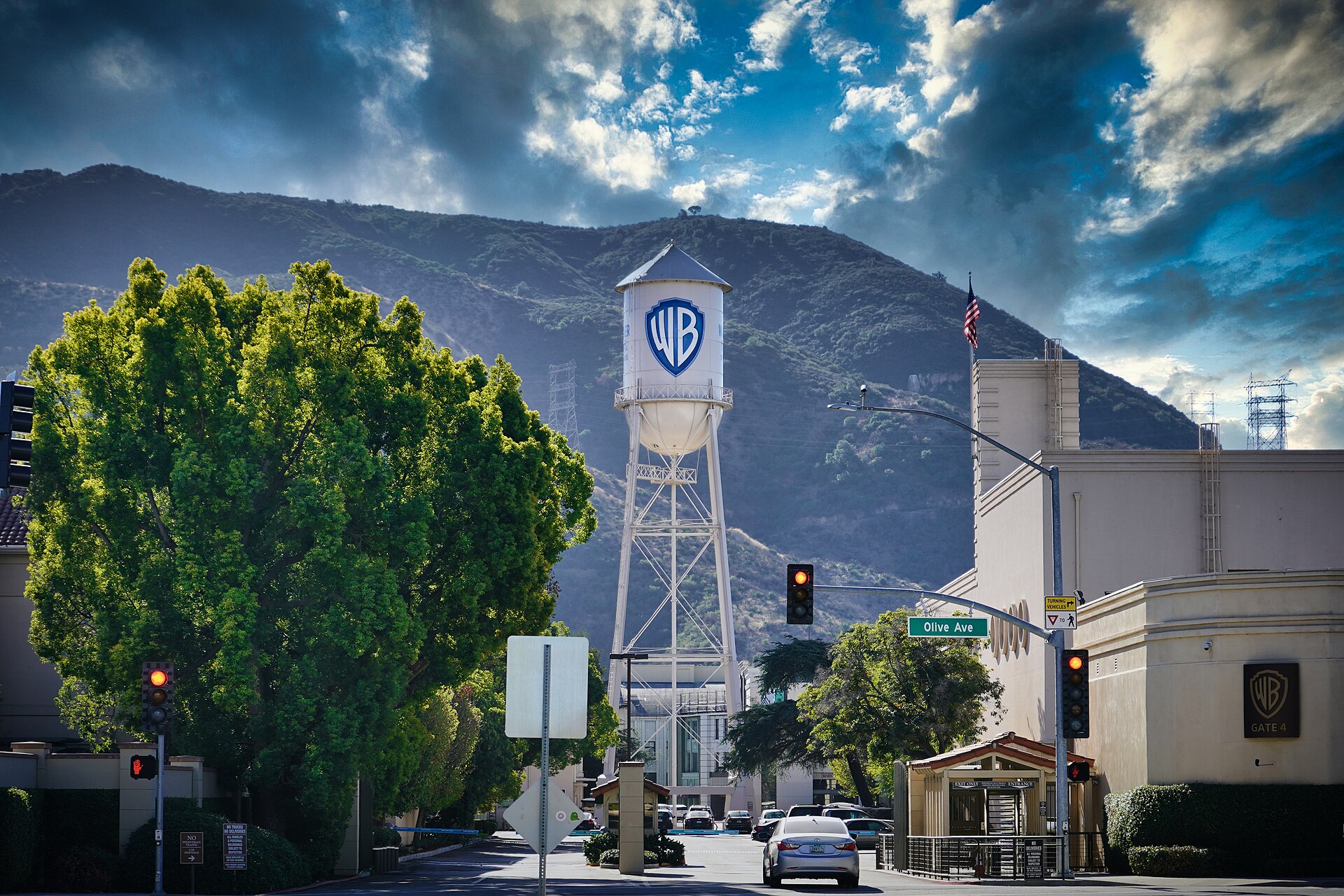 The Warner Bros. studio entrance on Olive Avenue in Burbank, with the water tower rising behind the gate.